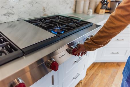 person using stove with propane