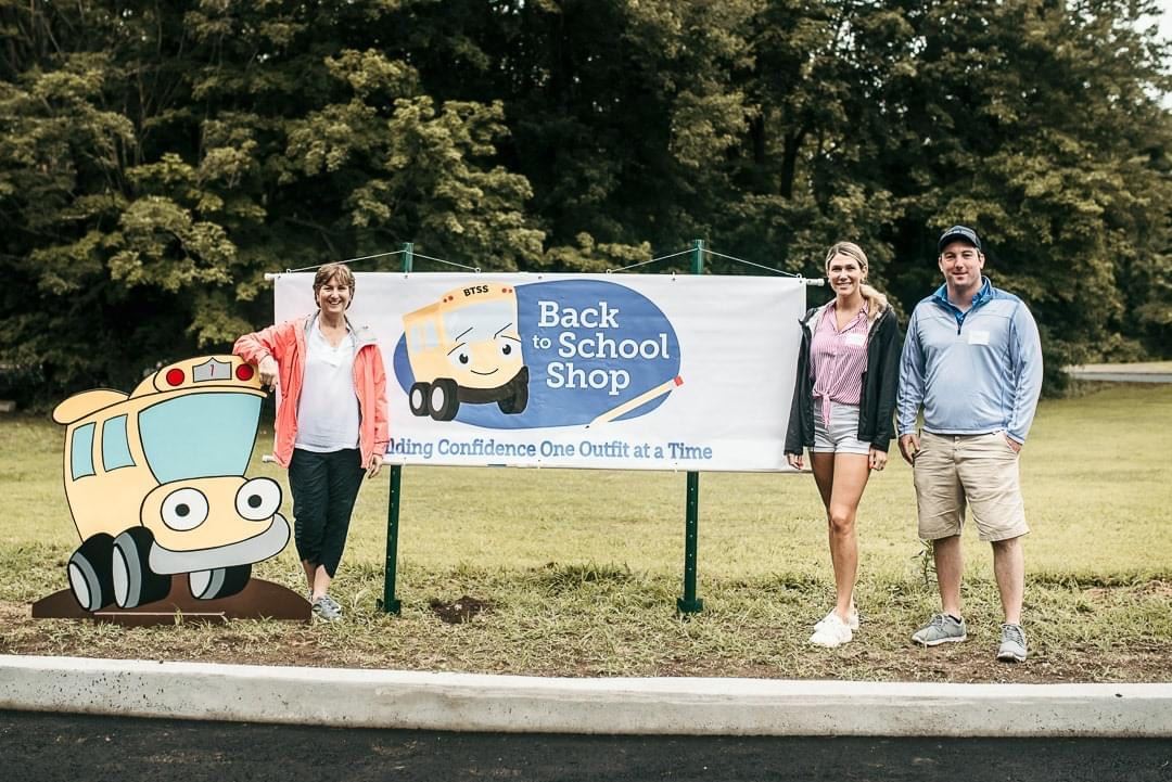 people standing in front of a levco sign